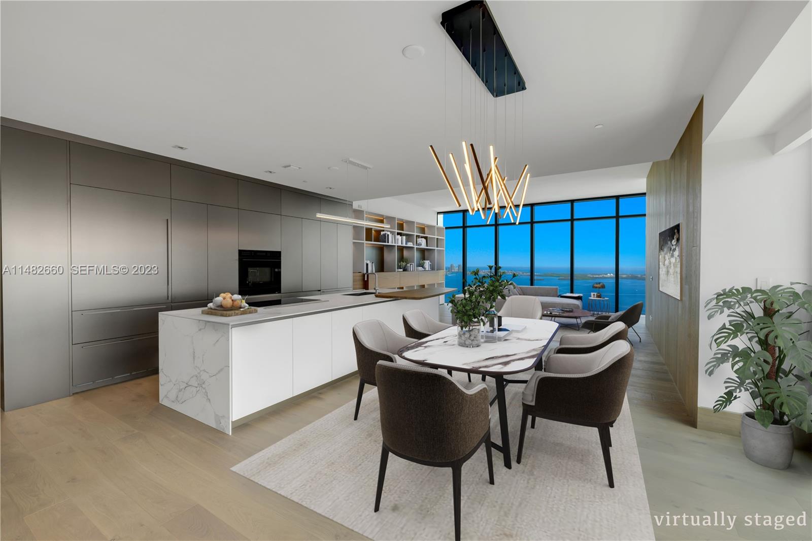 This virtually staged open-concept kitchen and dining area features marble surfaces and floor-to-ceiling windows — 1451 Brickell Ave # 4403, Miami FL 33131, MIAMI, FL