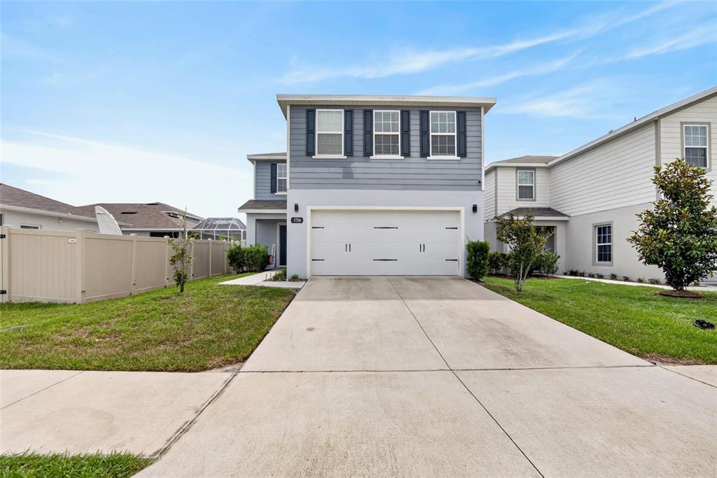 A two-story house with a gray exterior, a two-car garage, and a concrete driveway — 3706 ZEPHYR PRESERVE PLACE, ZEPHYRHILLS, FL