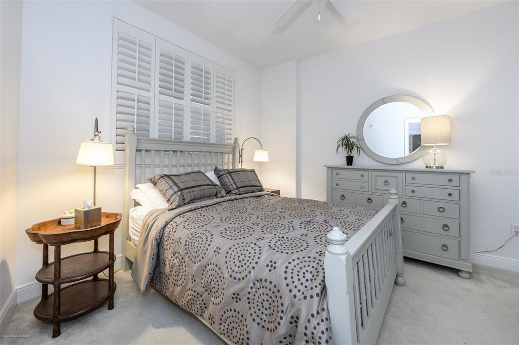 A white-walled entryway features a front door, a rug, and doorways leading to two bedrooms — 3313 SUNSET KEY CIRCLE UNIT 306, PUNTA GORDA, FL