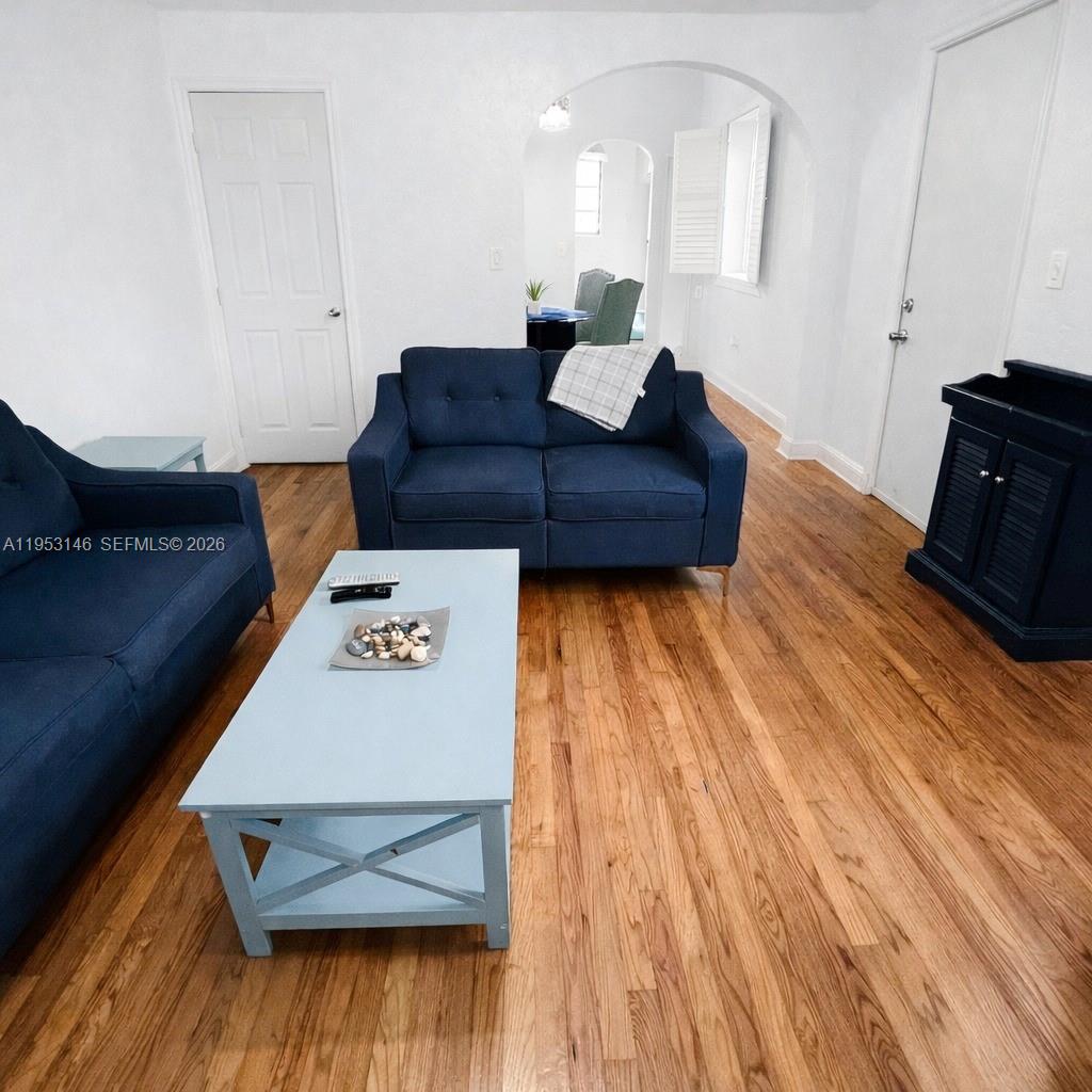 A living room features two blue sofas, a light blue coffee table, and hardwood floors — 928 Euclid Ave # 6, Miami Beach FL 33139, MIAMI BEACH, FL