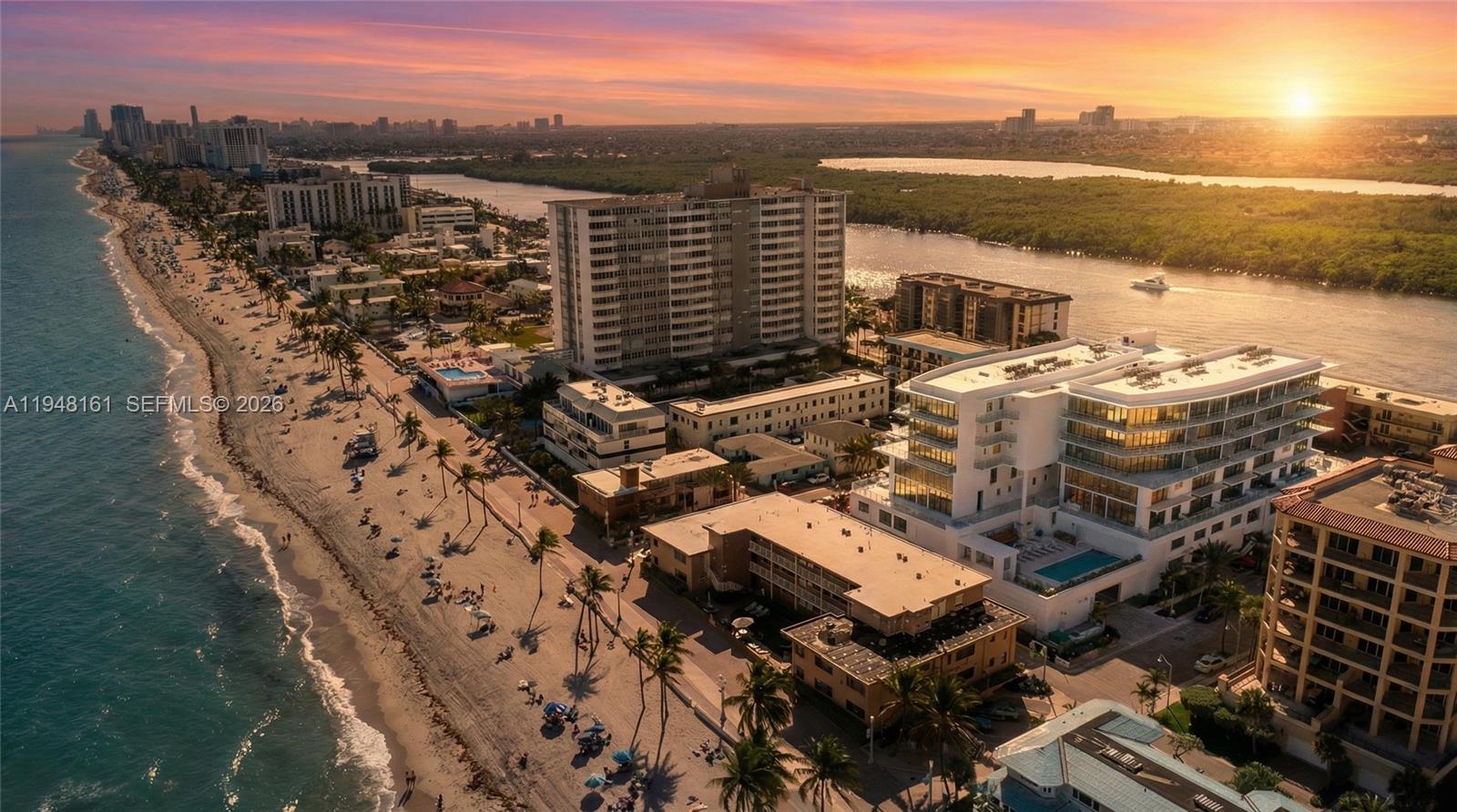 An aerial view shows a beach, ocean, and several multi-story buildings at sunset — 3319 N Ocean Drive, Hollywood FL 33019, HOLLYWOOD, FL