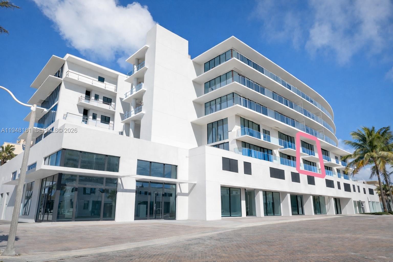 A modern white multi-story building with glass balconies and a highlighted section on the facade — 3319 N Ocean Drive, Hollywood FL 33019, HOLLYWOOD, FL