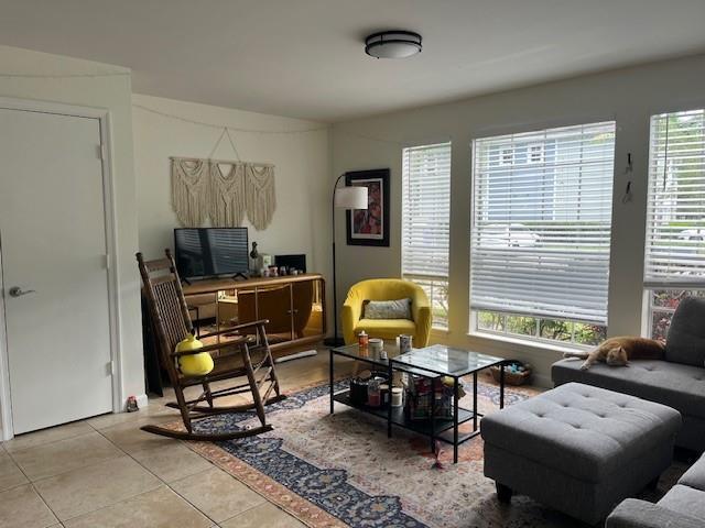 A living room features a rocking chair, a yellow armchair, and a gray sectional sofa — 1000 Crystal Way # A, Delray Beach FL 33444, DELRAY BEACH, FL