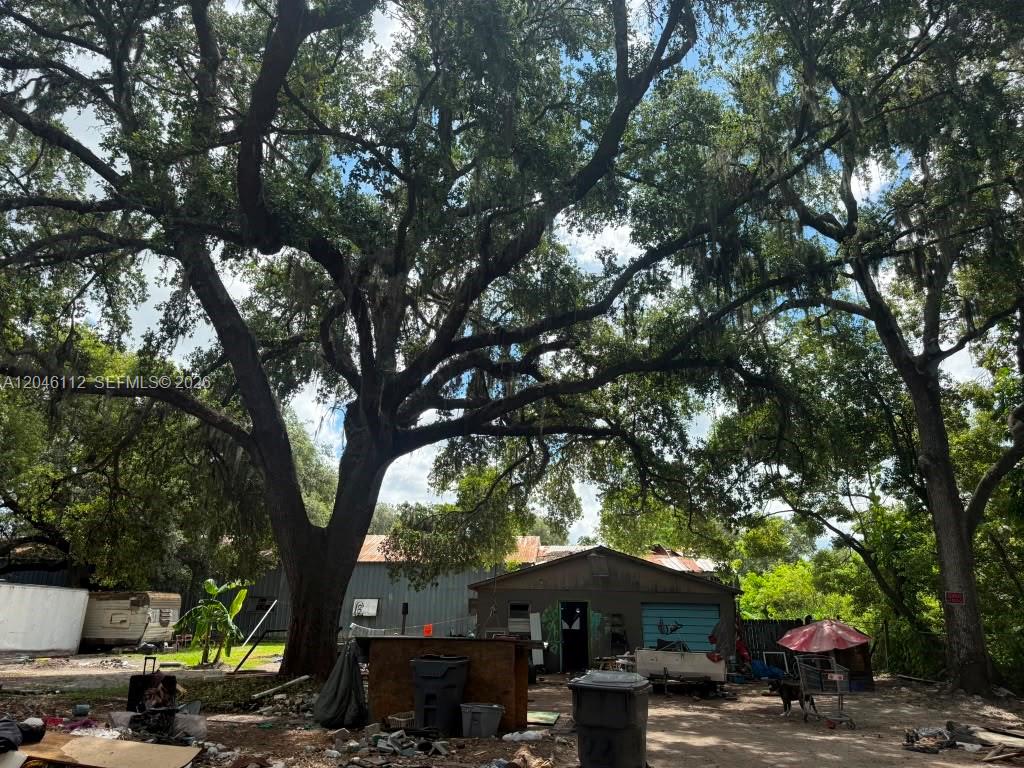 A large oak tree shades a yard with a small house and a trailer — 1035 David Street Lakeland, FL 338012, FL