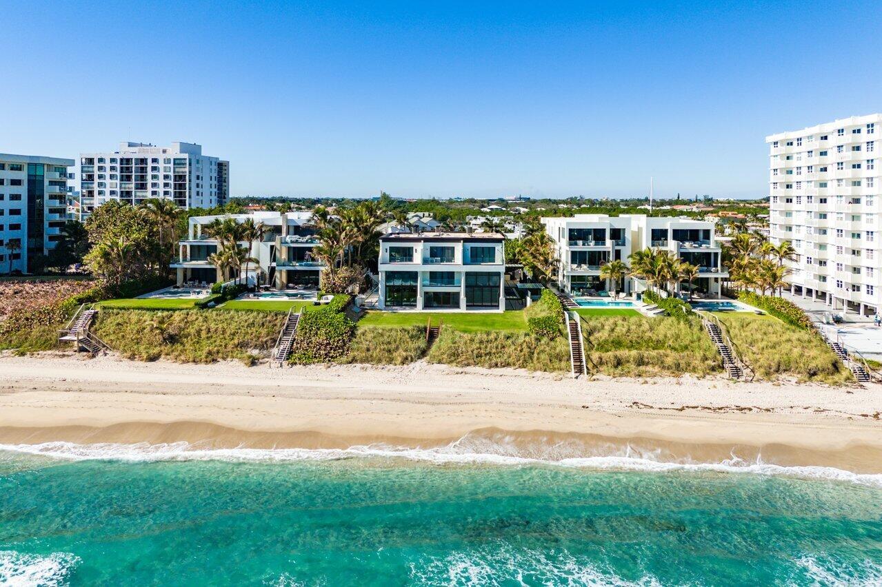 An aerial view shows several modern beachfront homes with pools situated along a sandy shore — 4517 S Ocean Boulevard, Highland Beach FL 33487, HIGHLAND BEACH, FL