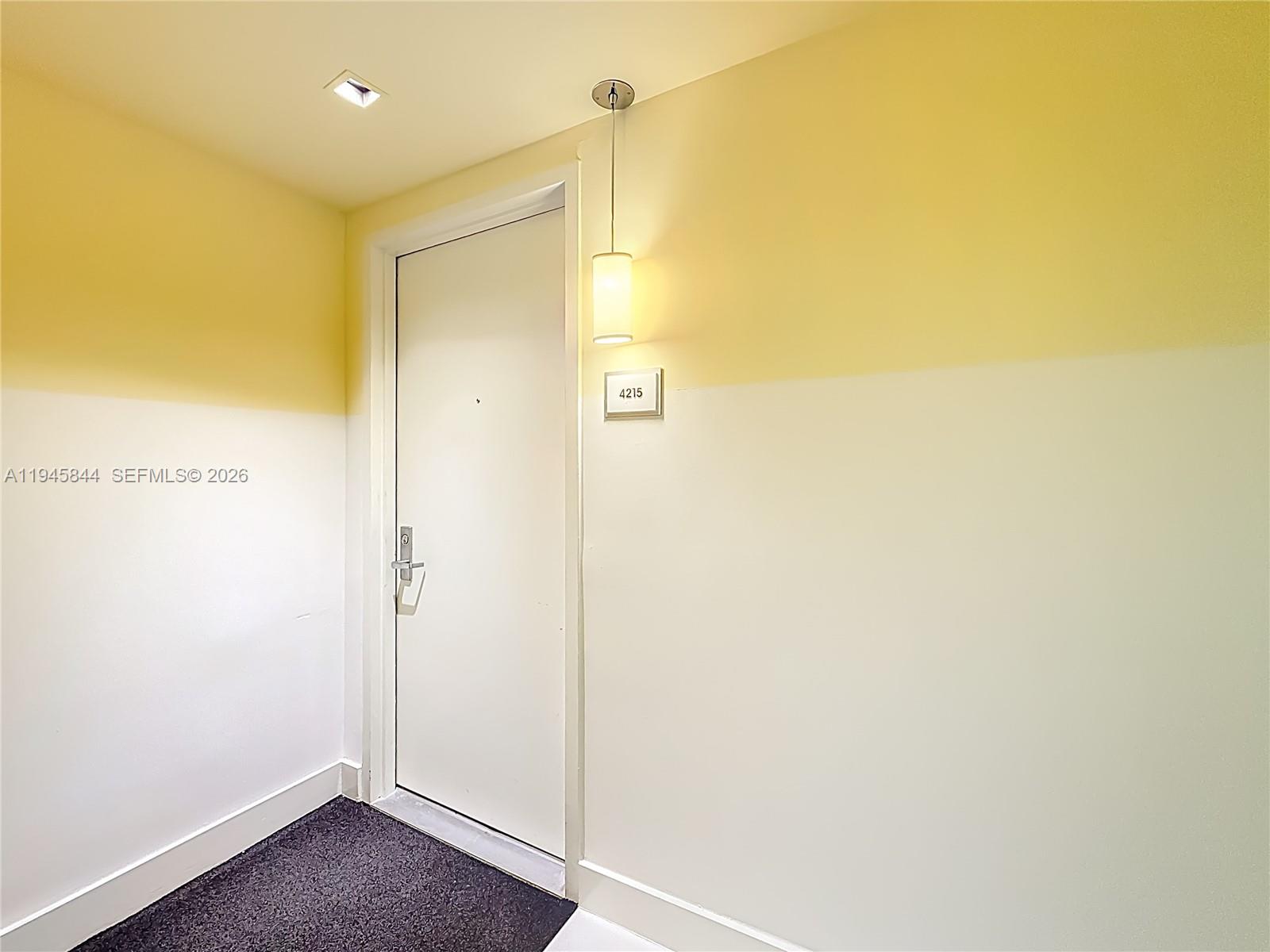 A white door with the number 4215 is set in a wall with two-toned paint — 475 Brickell Ave # 4215, Miami FL 33131, MIAMI, FL