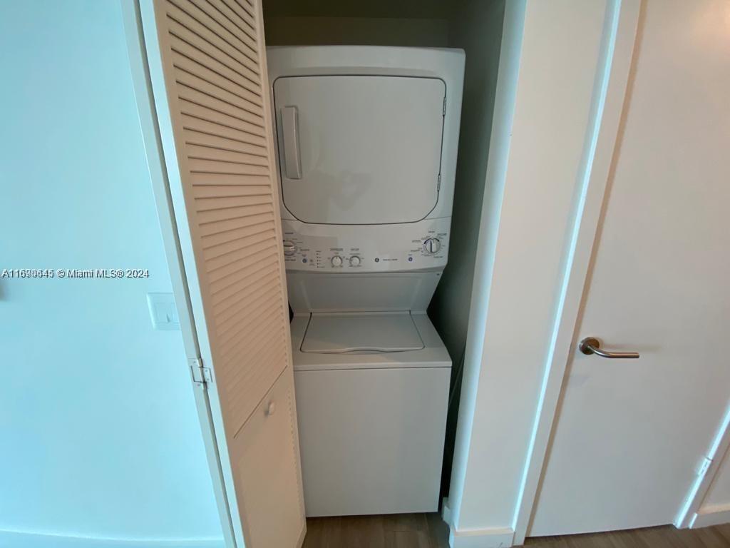 A white stacked washer and dryer unit is installed inside a small closet — 1100 S Miami Ave # 2602, Miami FL 33130, MIAMI, FL