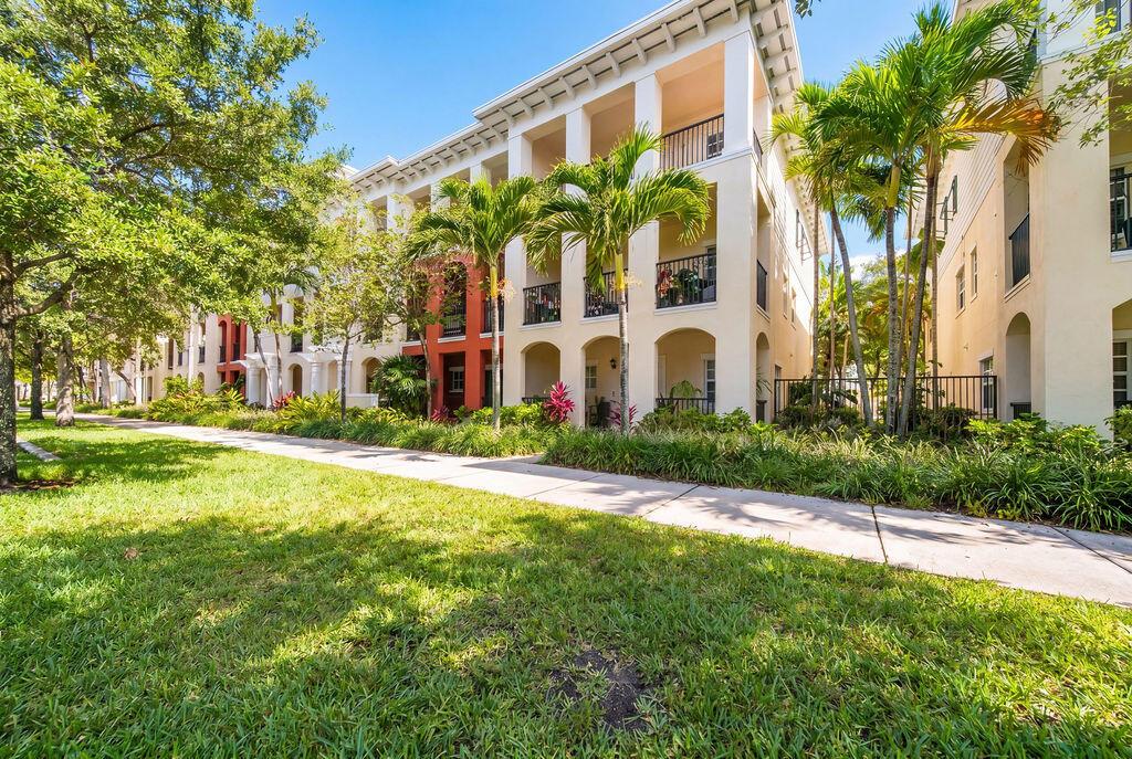 A multi-story apartment building with arched balconies and palm trees along a grassy lawn — 261 SW 6th Place, Pompano Beach FL 33060, POMPANO BEACH, FL