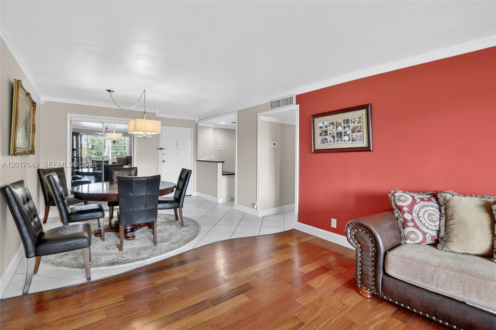 A dining area with tile floors and a living space with hardwood floors — 6600 Cypress Rd # 504, Plantation FL 33317, PLANTATION, FL