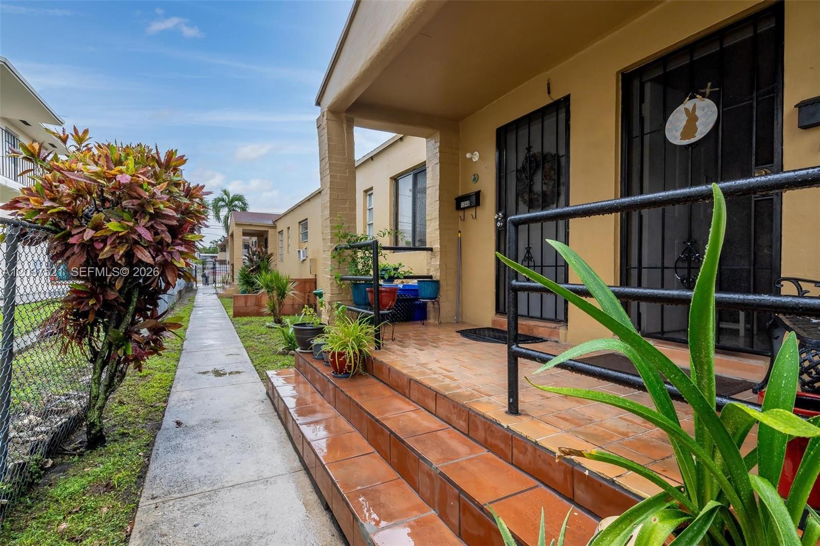A tiled front porch with steps leads to two entrance doors with security grilles — 1345 SW 7th ST, Miami FL 33135, MIAMI, FL