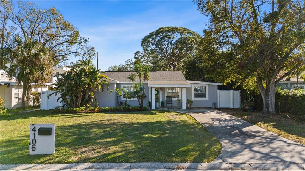 A single-story gray house with a concrete driveway and a front lawn with trees — 4106 W BAY VIEW AVENUE, TAMPA, FL