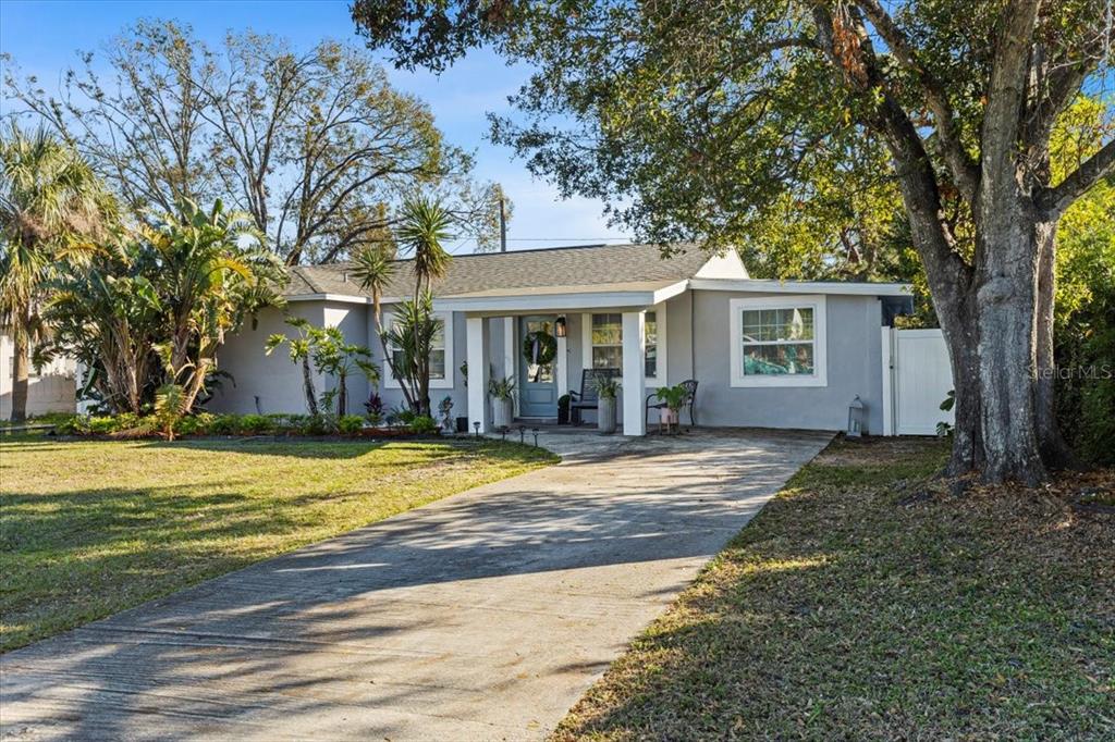 A single-story gray house with a concrete driveway and a covered front porch — 4106 W BAY VIEW AVENUE, TAMPA, FL