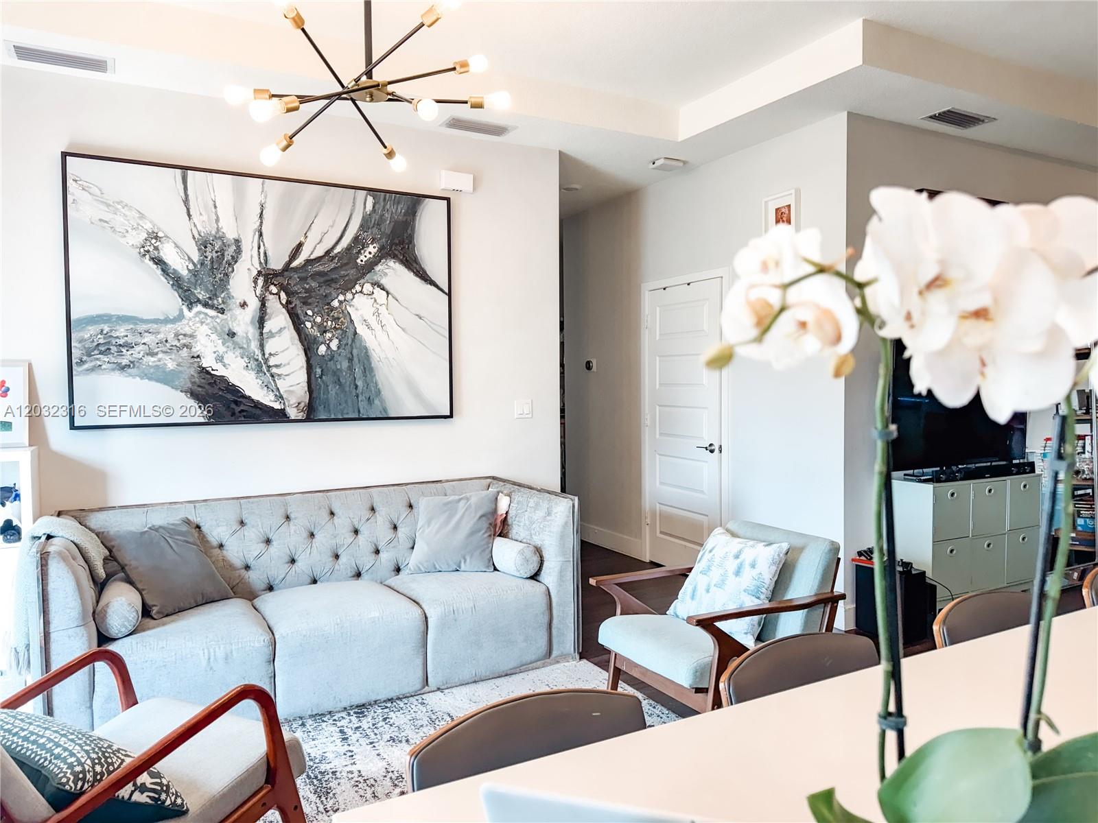 A living room features a tufted gray sofa, two armchairs, and a large abstract painting — 10455 NW 82nd St # 32, Doral FL 33178, DORAL, FL
