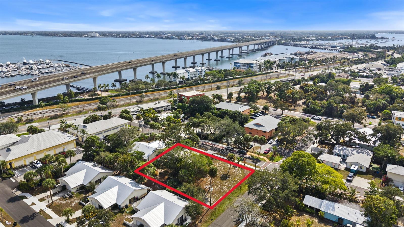 An aerial view shows a vacant, rectangular lot outlined in red within a residential neighborhood — 621 NW Australian Street, Stuart FL 34994, STUART, FL