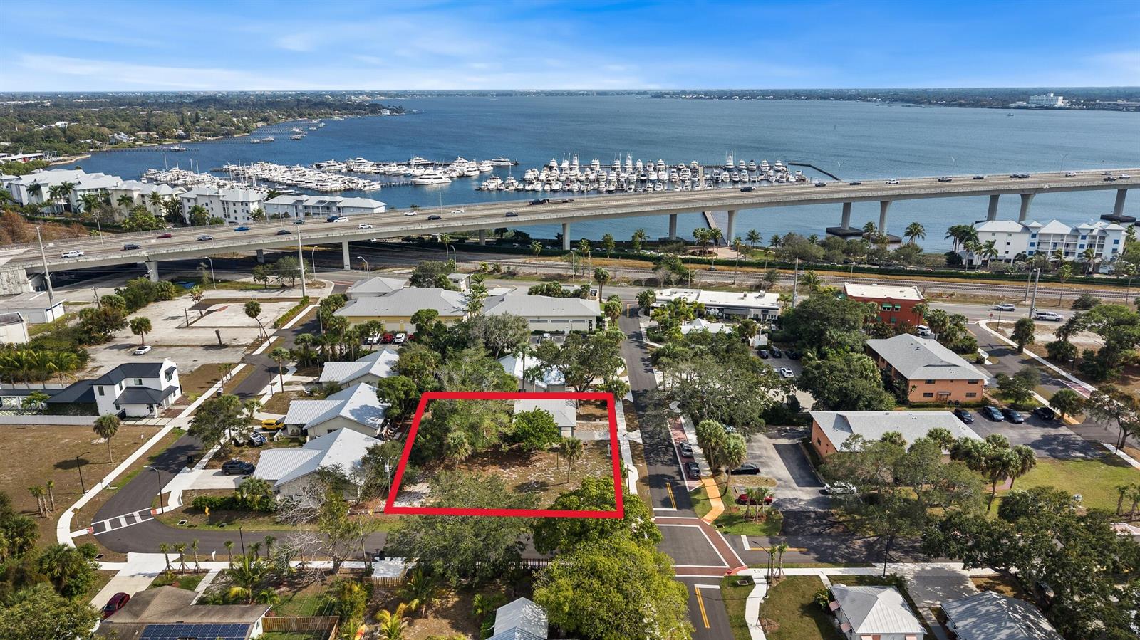 An aerial view shows a rectangular vacant lot outlined in red near a marina — 621 NW Australian Street, Stuart FL 34994, STUART, FL