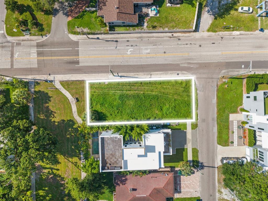 An aerial view shows a rectangular vacant lot outlined in white next to a house — 2701 N MYRTLE AVENUE, TAMPA, FL