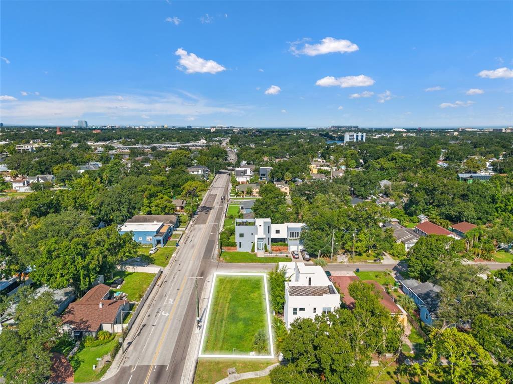 An aerial view shows a vacant rectangular lot outlined in white next to residential buildings — 2701 N MYRTLE AVENUE, TAMPA, FL