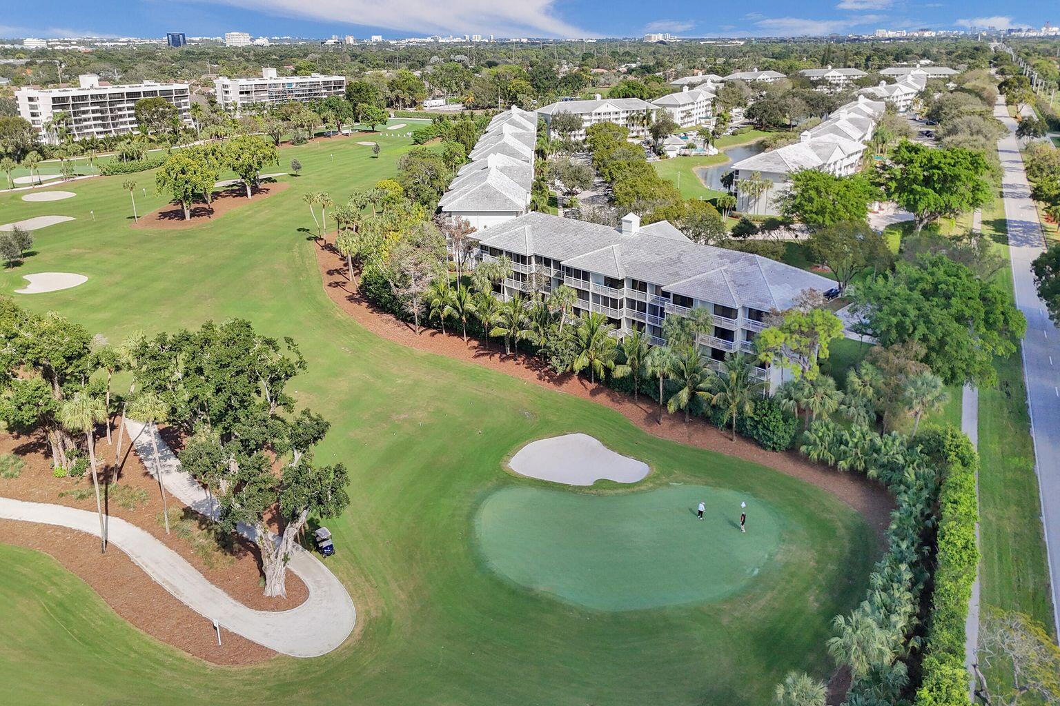 An aerial view of a golf course green with two golfers near a residential building — 6193 Balboa Circle # 201, Boca Raton FL 33433, BOCA RATON, FL