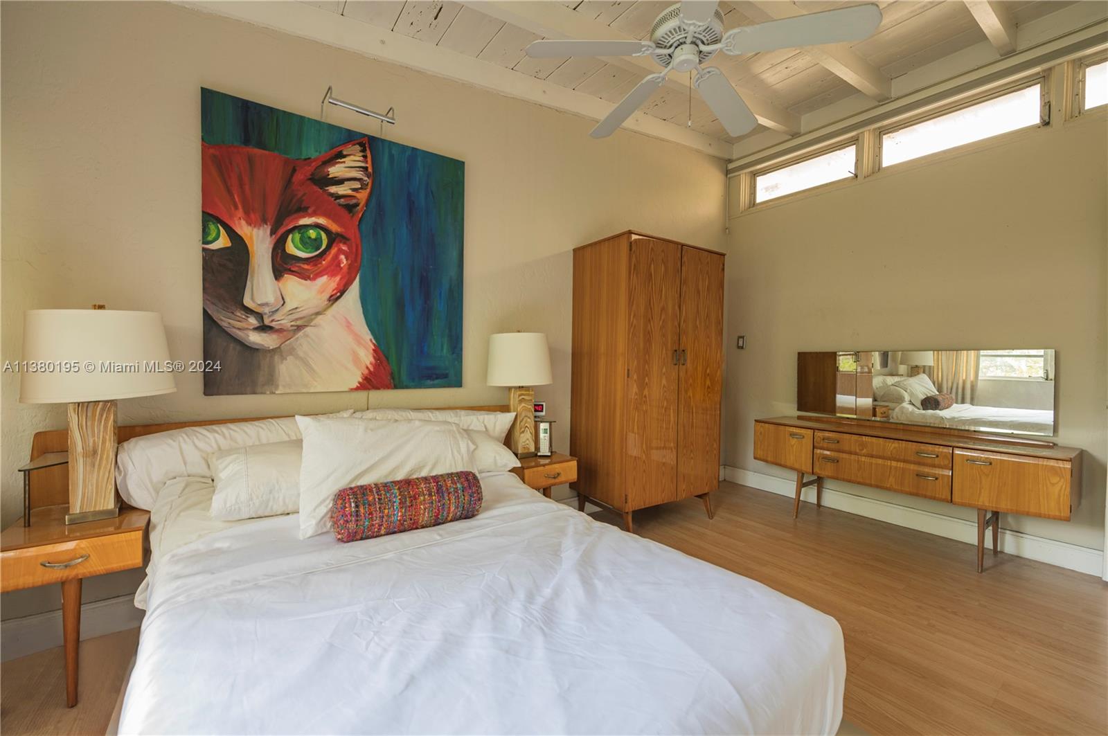 A bedroom features a large cat painting, wooden furniture, a ceiling fan, and light flooring — 2018 Fletcher St, Hollywood FL 33020, HOLLYWOOD, FL