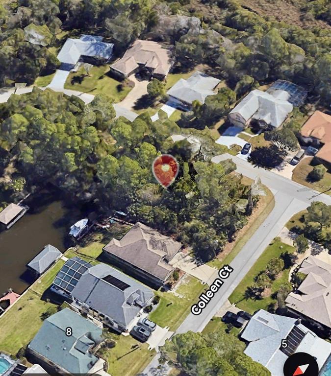 An aerial view shows a wooded residential lot on a cul-de-sac near a canal — 43 COLECHESTER LANE, PALM COAST, FL