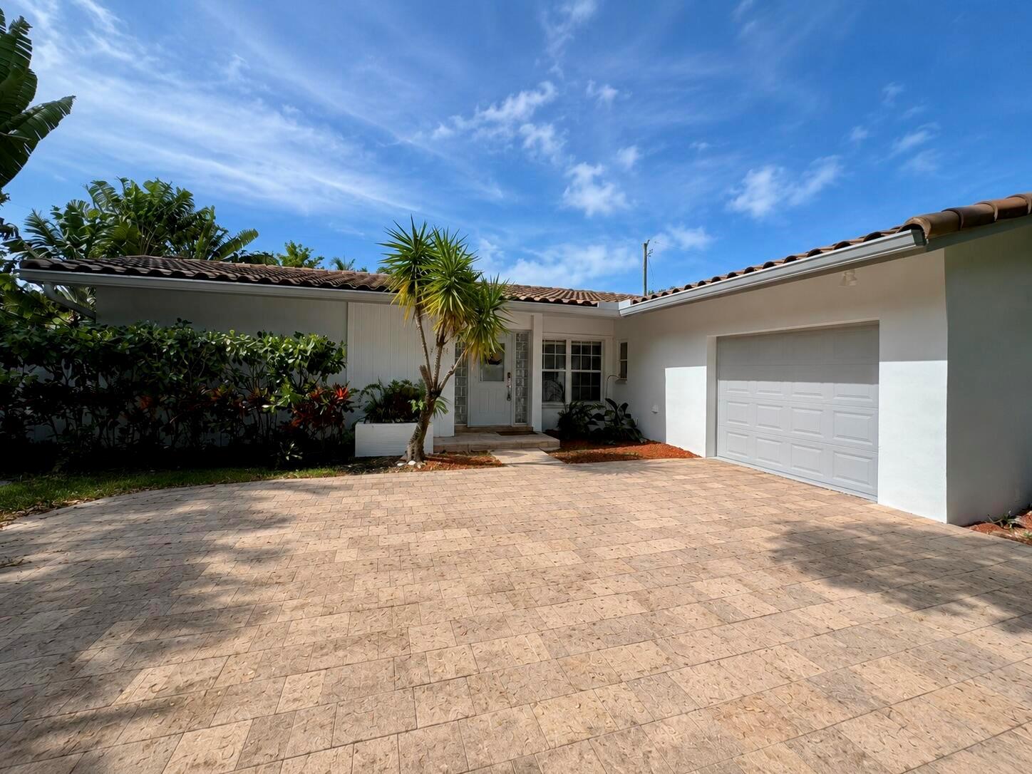 A single-story house with a white exterior, tiled roof, and a paved driveway — 3230 Aqua Vista Drive, Pompano Beach FL 33062, POMPANO BEACH, FL