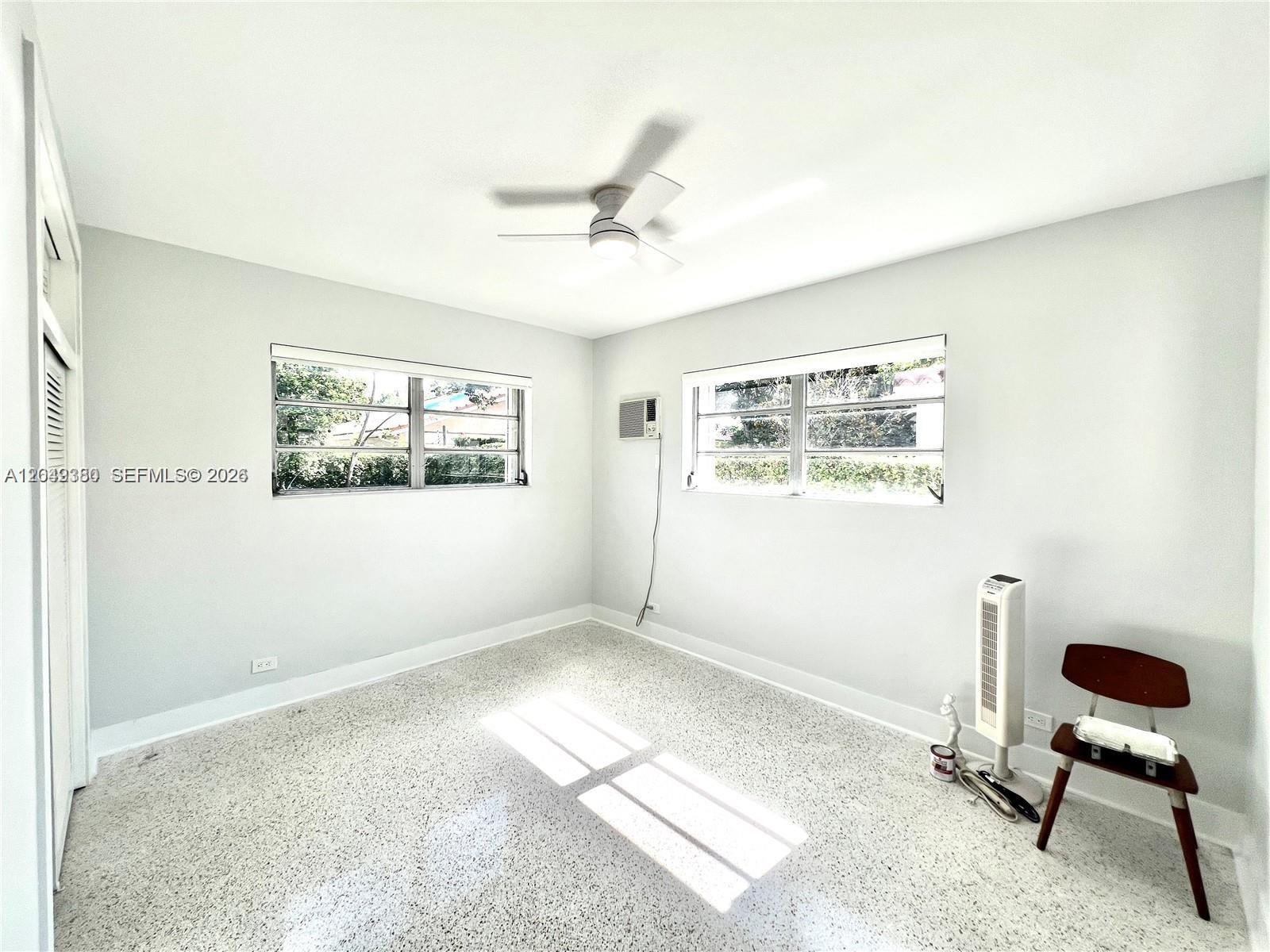 An empty bedroom features light gray walls, a ceiling fan, and speckled terrazzo flooring — 2245 SW 25th Ter # 0, Miami FL 33133, MIAMI, FL