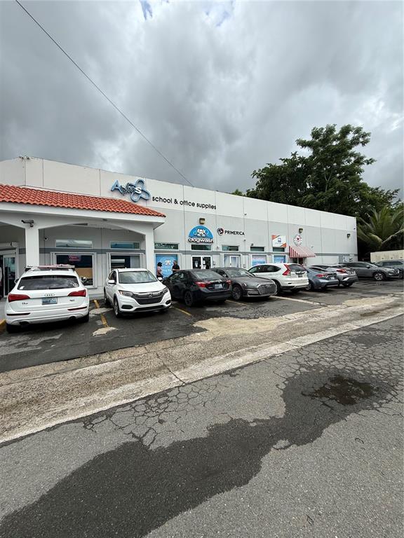 A one-story commercial building with several storefronts and a parking lot in front — 177 CALLE ROMERILLO, SAN JUAN, PR