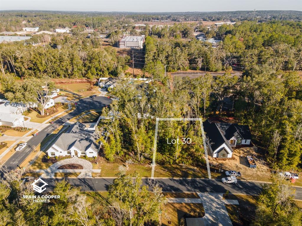 An aerial view shows a vacant wooded lot marked as Lot 30 between two houses — 14134 SW 7TH PLACE, NEWBERRY, FL