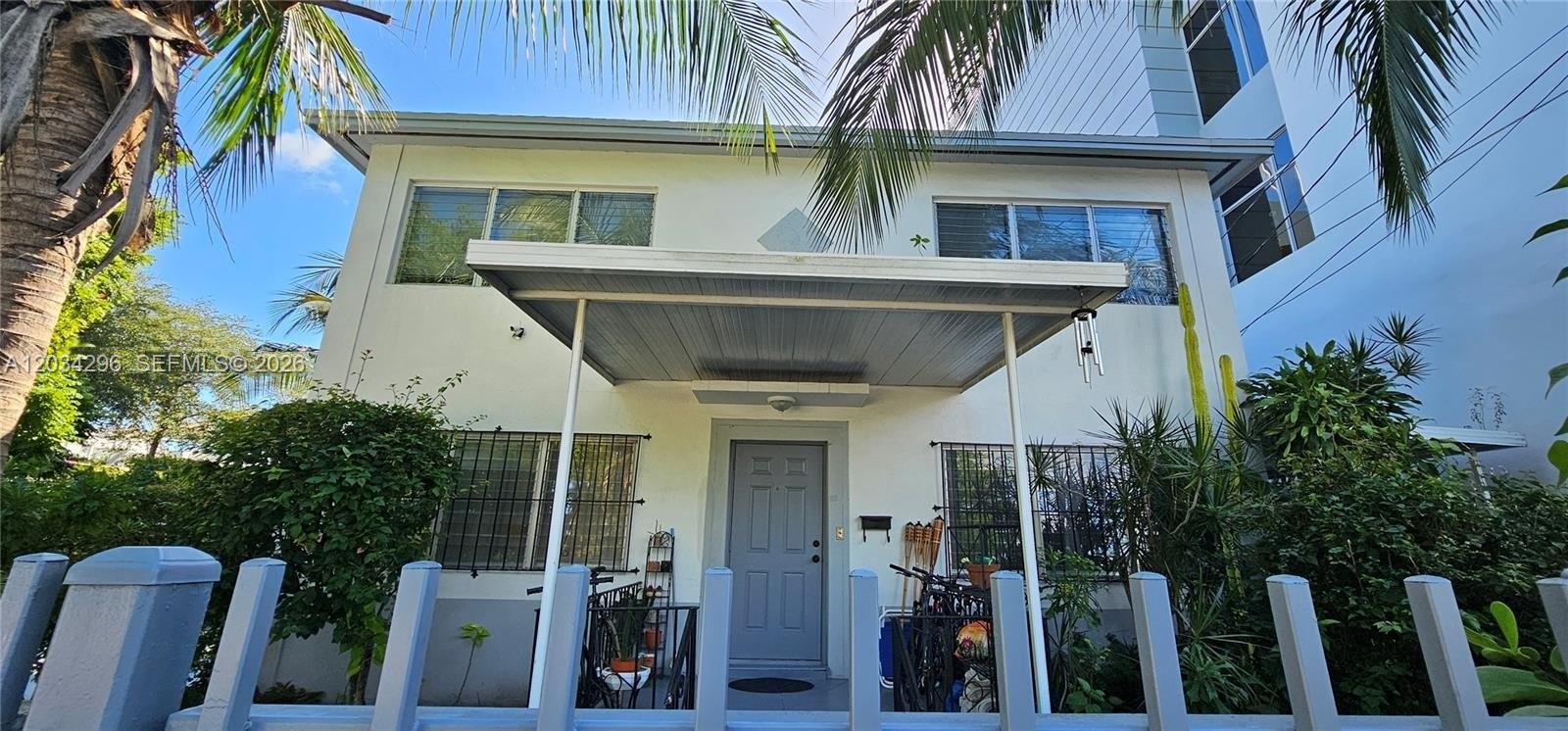 A two-story white building features a covered front entrance and a metal fence — 364 SW 11th St, Miami FL 33130, MIAMI, FL