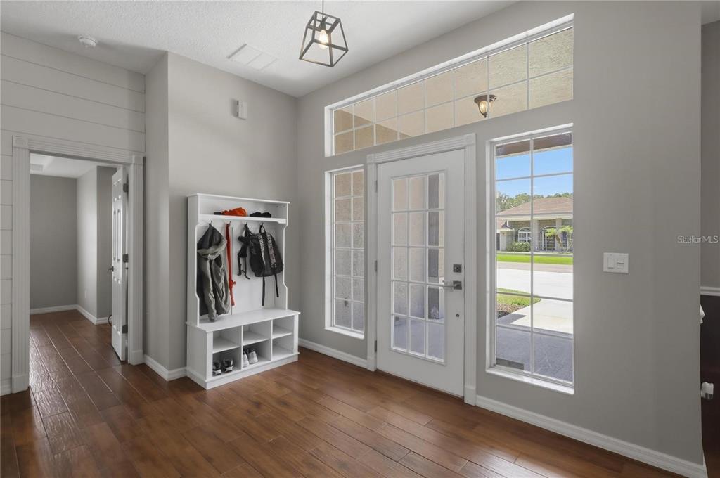 A wide view of the back of a single-story house with a large grassy yard — 62 SENTINEL TRAIL, PALM COAST, FL