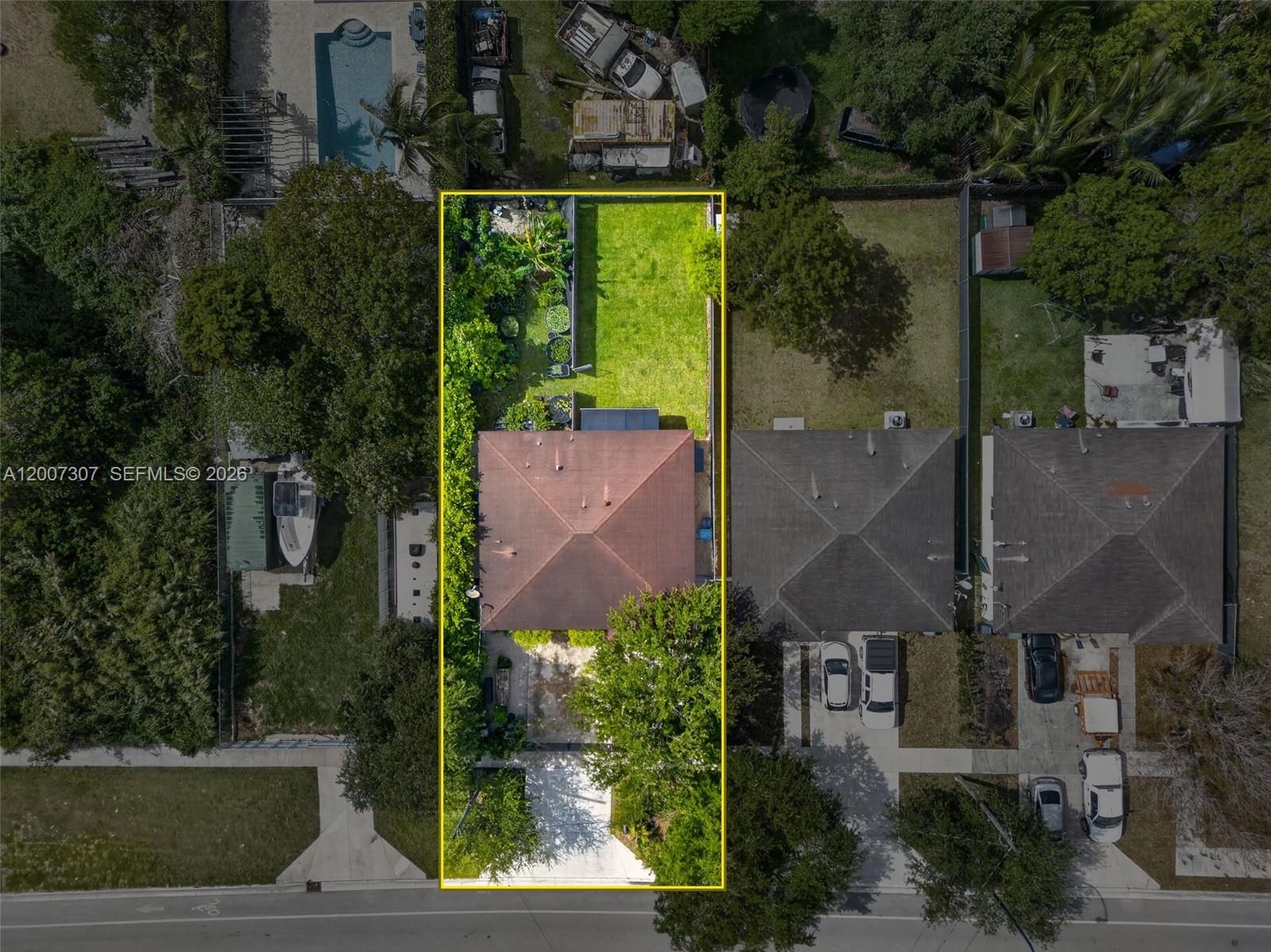 An aerial view shows a residential property with a house, driveway, and backyard — 12310 SW 216th St, Miami FL 33170, MIAMI, FL