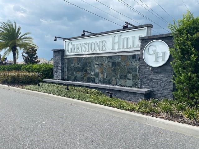 A stone monument sign for Greystone Hills stands beside a road with a palm tree — 8864 SW 49th CIRCLE, Ocala FL 34476, OCALA, FL