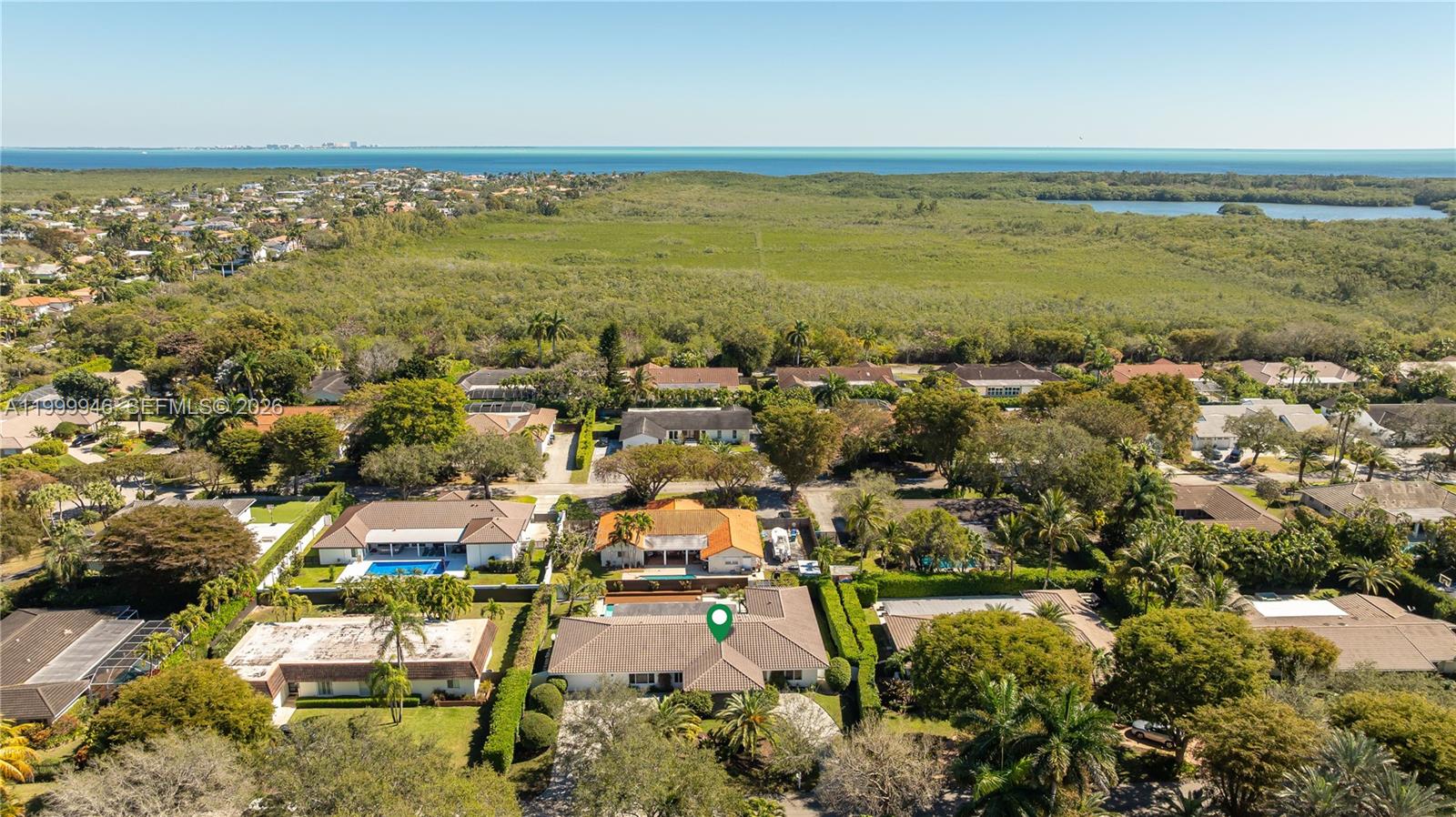An aerial view shows a residential neighborhood with a marked house and surrounding vegetation — 13303 SW 58th Ave, Pinecrest FL 33156, PINECREST, FL