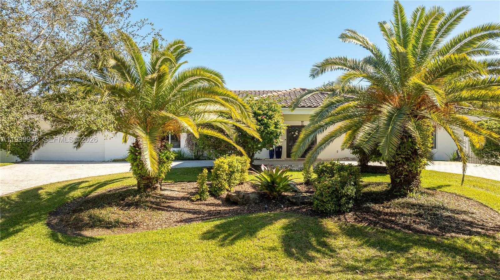 A single-story house with a paved driveway and two large palm trees in the front yard — 13303 SW 58th Ave, Pinecrest FL 33156, PINECREST, FL