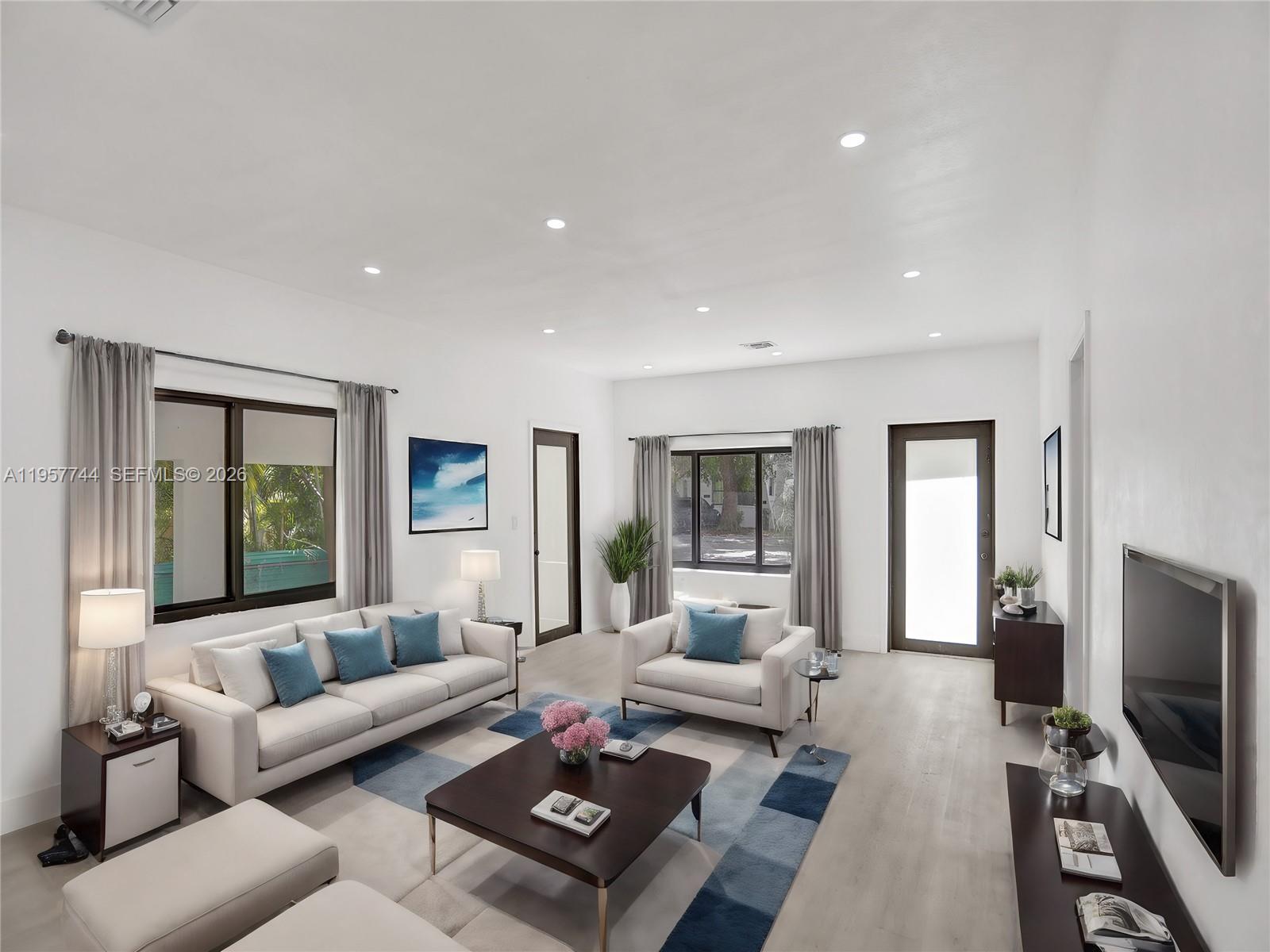 A bright living room features white walls, light wood floors, and a modern furniture arrangement — 759 NE 127th St, North Miami FL 33161, NORTH MIAMI, FL