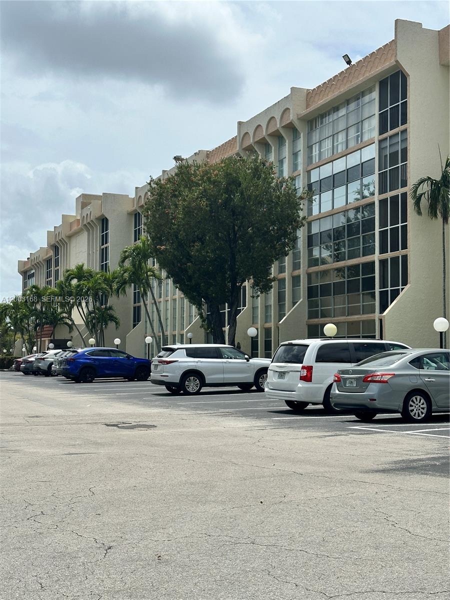 A multi-story residential building with a parking lot in the foreground — 701 Three Islands Blvd # 110, Hallandale Beach FL 33009, HALLANDALE BEACH, FL
