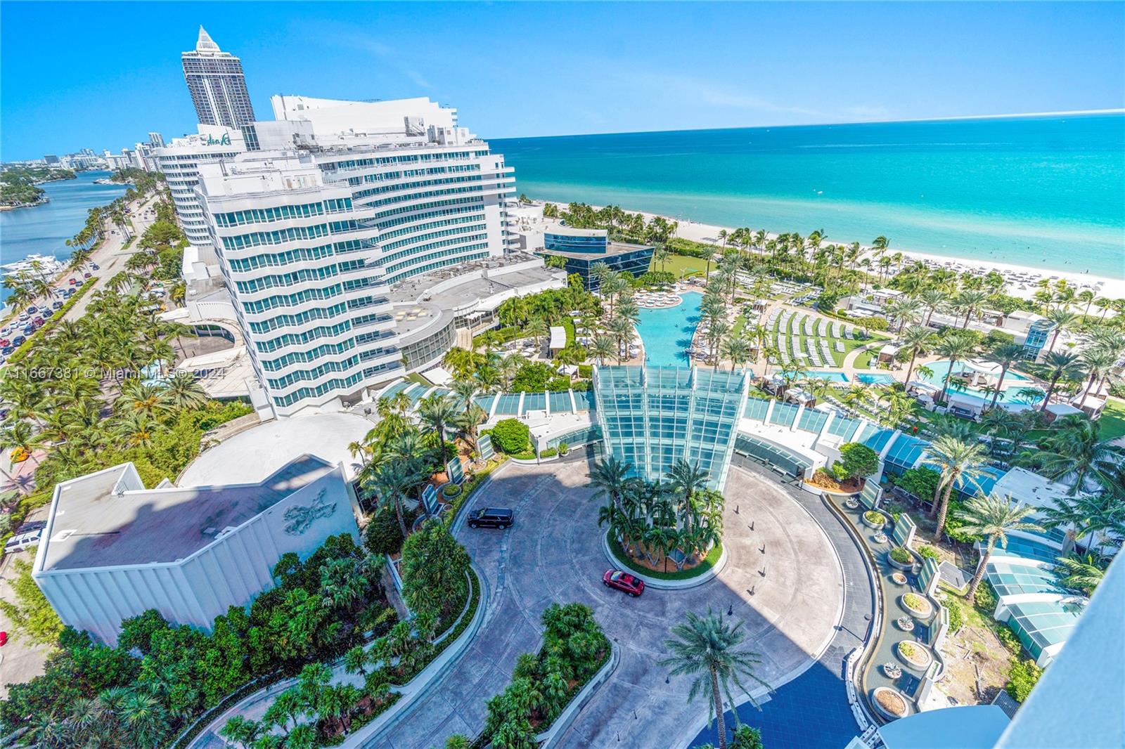 An aerial view shows a large hotel complex with a circular driveway, pools, and beach — 4401 Collins Ave # 1709, Miami Beach FL 33140, MIAMI BEACH, FL