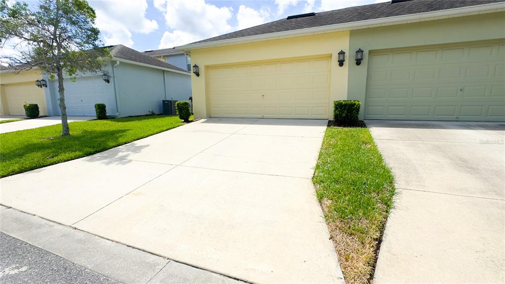 The exterior view shows two adjacent houses with light-colored garages and concrete driveways — 1217 SEBURN ROAD, APOPKA, FL