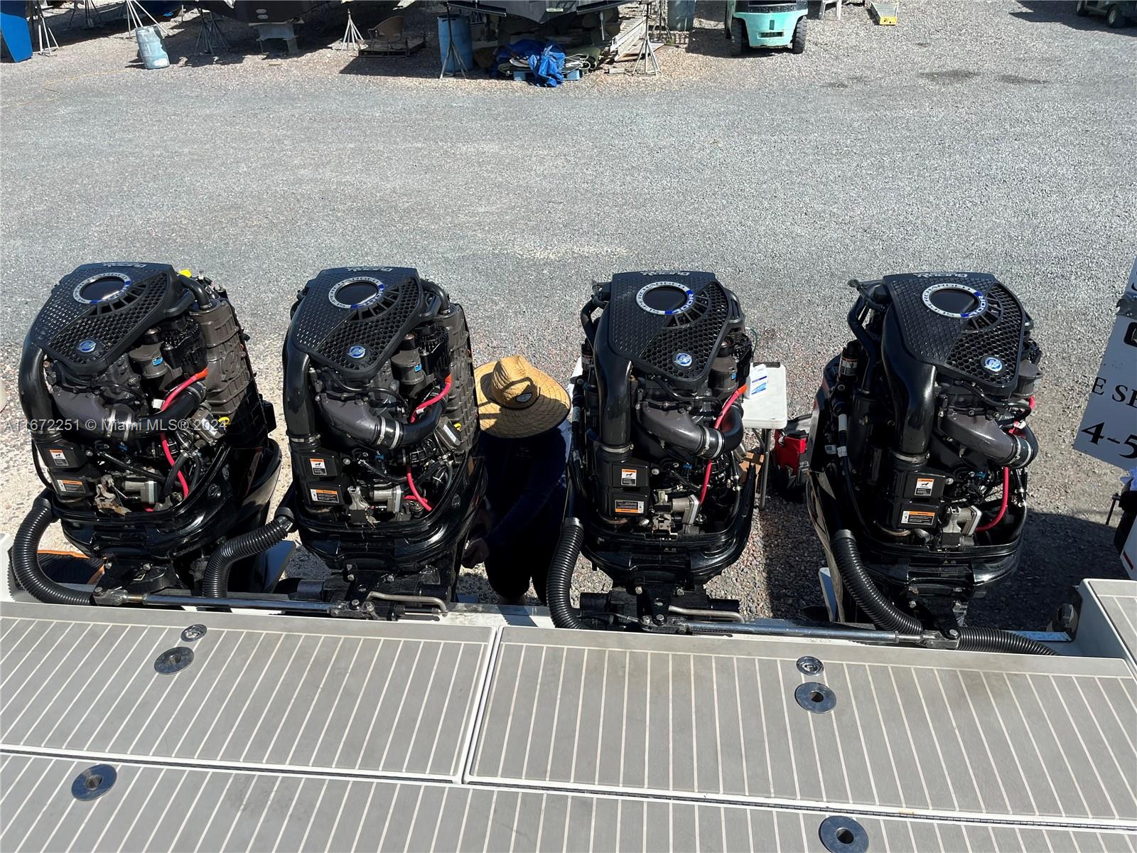 Four outboard boat motors are mounted on the stern of a vessel with deck flooring — 101425 Overseas Highway, Key Largo FL 33037, KEY LARGO, FL