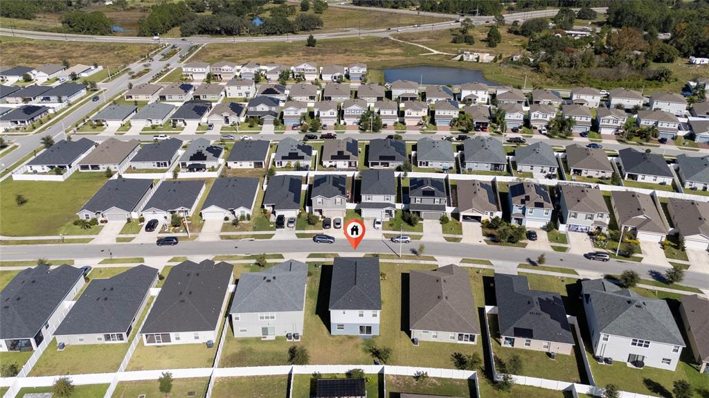 An aerial view shows a suburban neighborhood with rows of houses and a marked property — 419 LILY LANE, DAVENPORT, FL