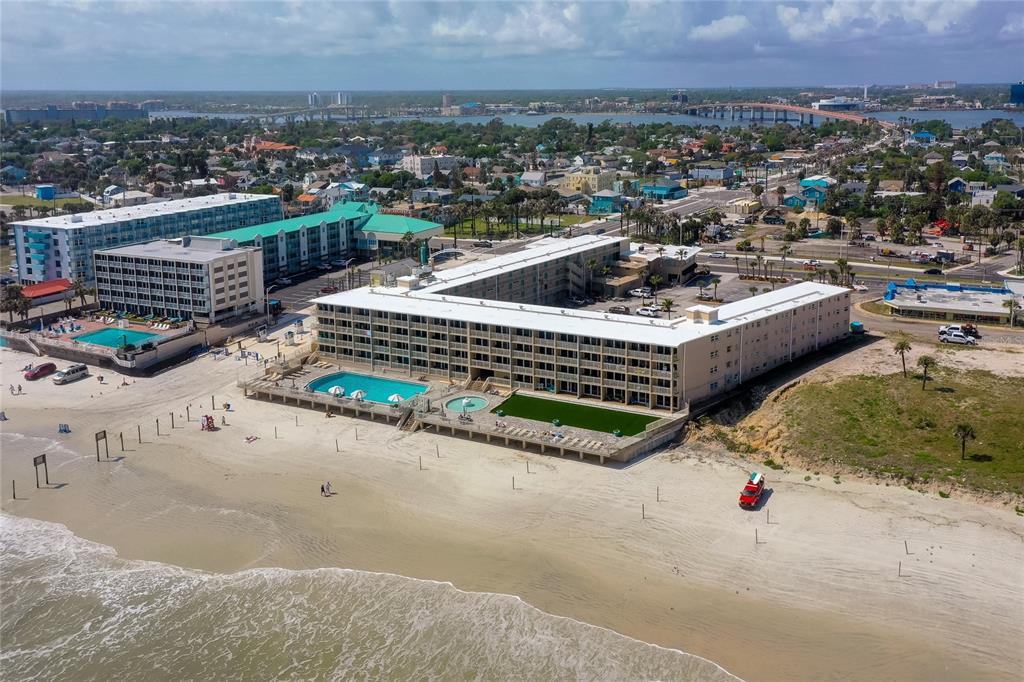 An aerial view shows a U-shaped beachfront hotel with a pool deck and parking lot — 219 S ATLANTIC AVENUE UNIT 237, DAYTONA BEACH, FL