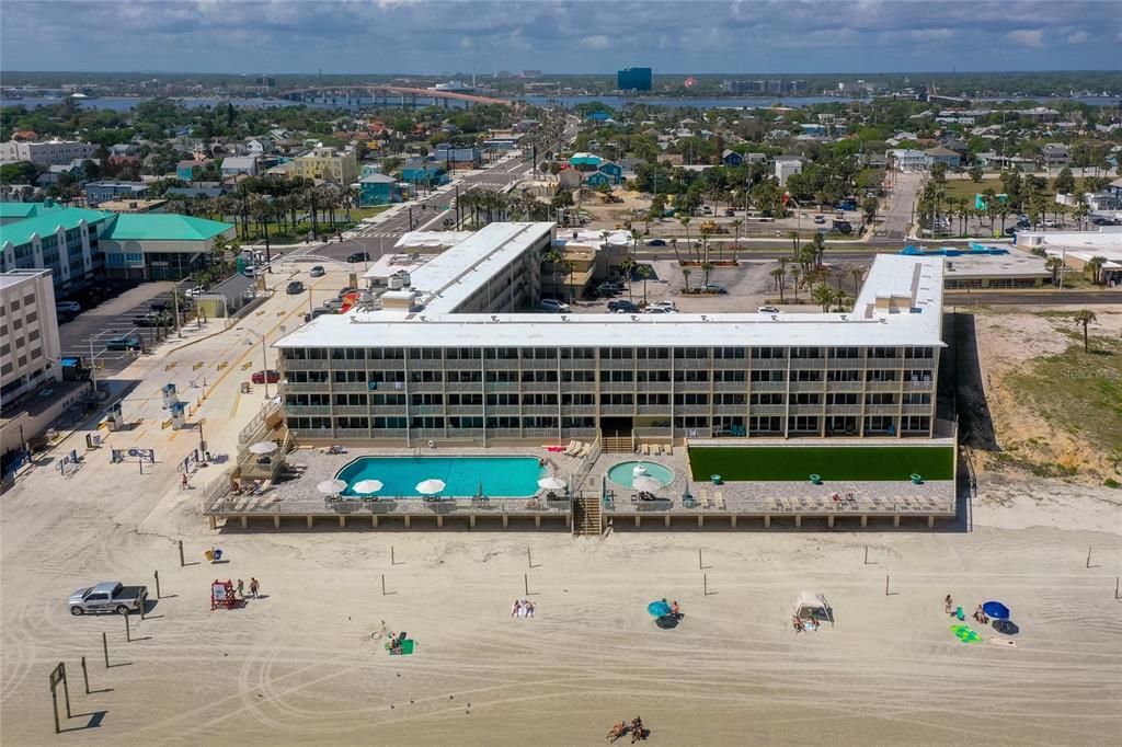 An aerial view of a beachfront hotel with a swimming pool and a parking lot — 219 S ATLANTIC AVENUE UNIT 237, DAYTONA BEACH, FL