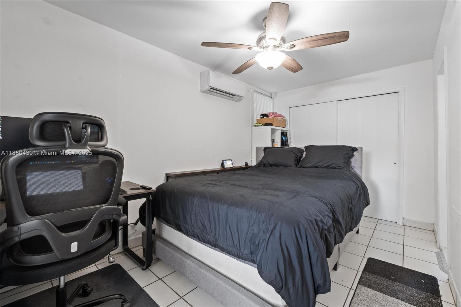 A bedroom features a bed with black bedding, a desk, a chair, and a ceiling fan — 2453 SW 17th St # 2, Miami FL 33145, MIAMI, FL