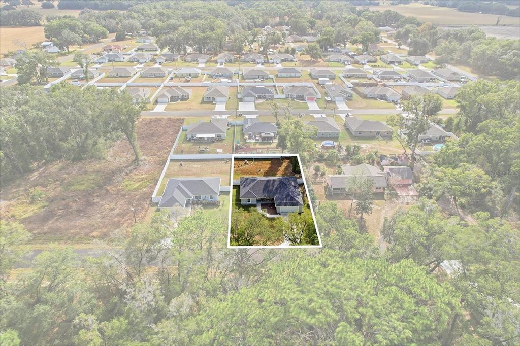 An aerial view shows a residential house highlighted within a suburban neighborhood — 17636 SW 114TH STREET, DUNNELLON, FL