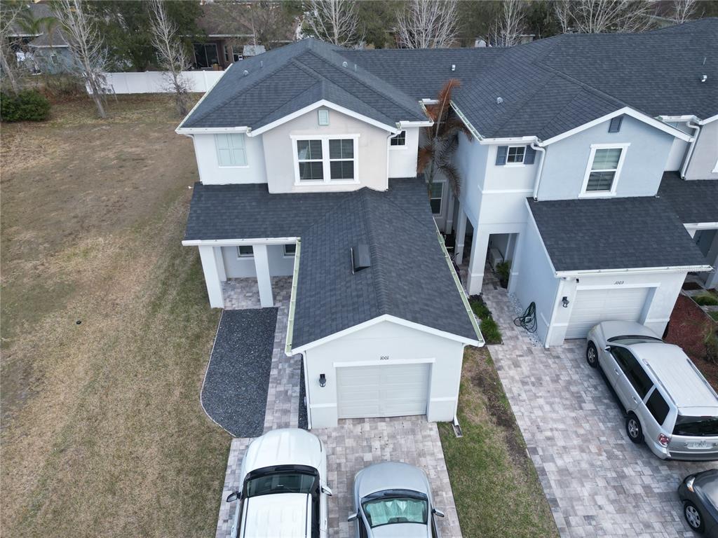 An aerial view shows the exterior of a two-story residential building with attached garages — 1001 LA MIRADA COURT, KISSIMMEE, FL