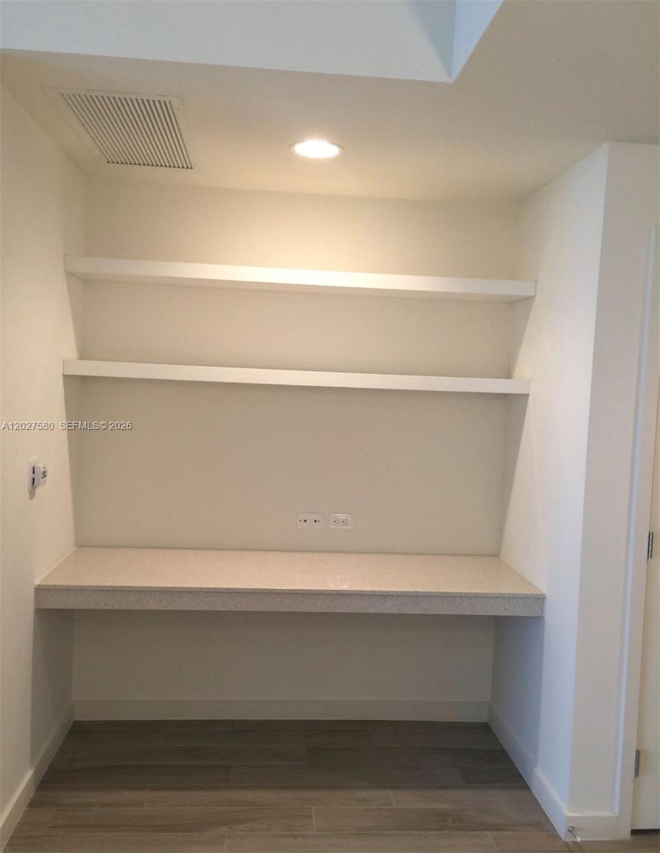 A built-in desk with a stone countertop and two white floating shelves above — 999 SW 1st Ave # 2005, Miami FL 33130, MIAMI, FL