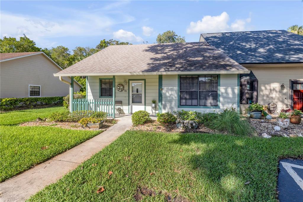 A single-story house with light siding, a shingled roof, and a front walkway — 232 N RIDGEWOOD AVENUE UNIT 23, EDGEWATER, FL