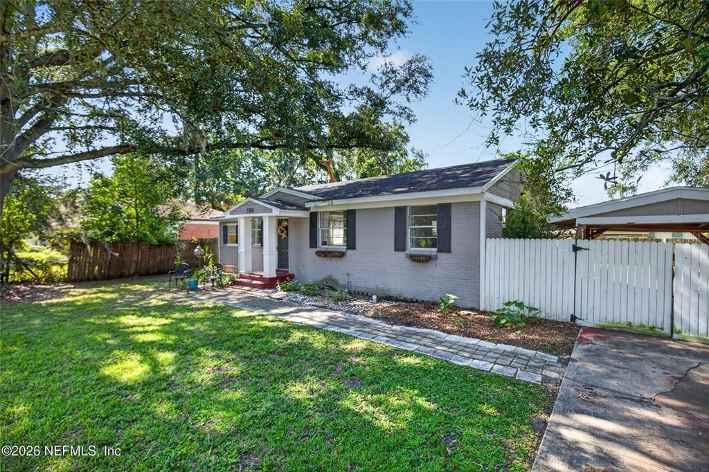 A gray brick house with a white front porch and a stone walkway — 3308 SHERIDAN ROAD, JACKSONVILLE, FL