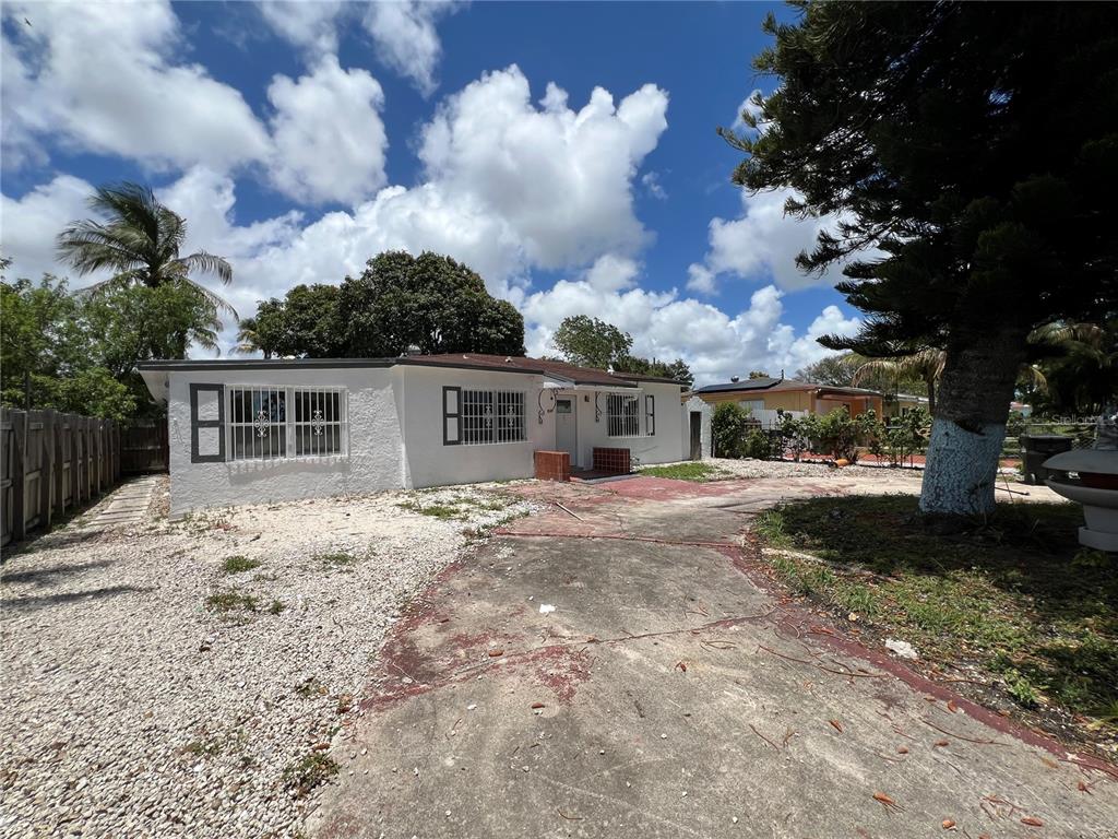 A white, single-story house with security bars on the windows and a concrete driveway — 845 NW 130TH STREET, NORTH MIAMI, FL