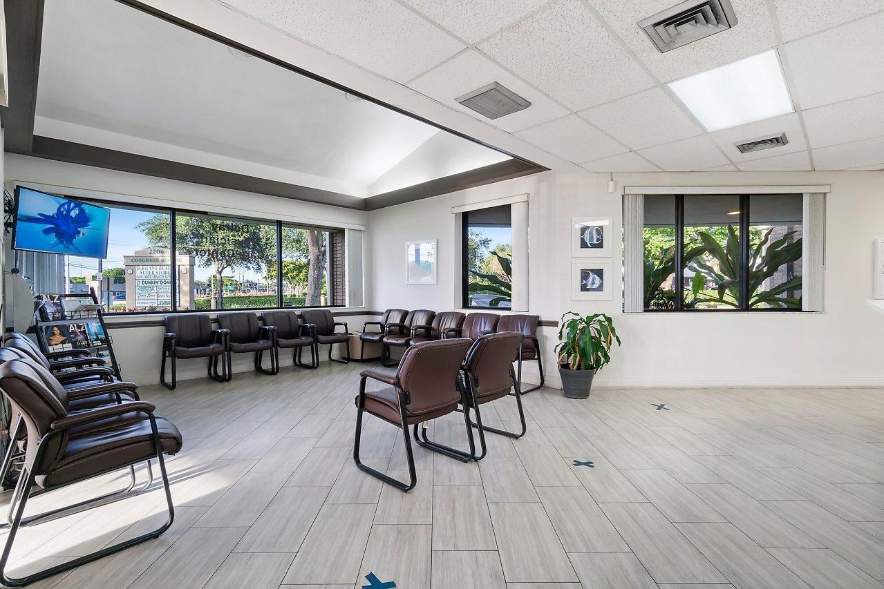 A waiting room features brown chairs, light wood-look flooring, and large windows with exterior views — 2280 W Atlantic Avenue, Delray Beach FL 33445, DELRAY BEACH, FL